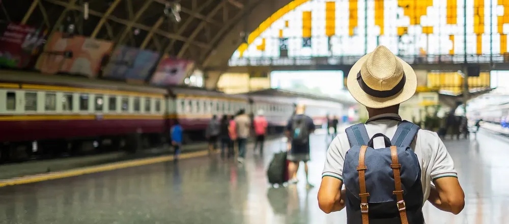 Man with backpack in train station
